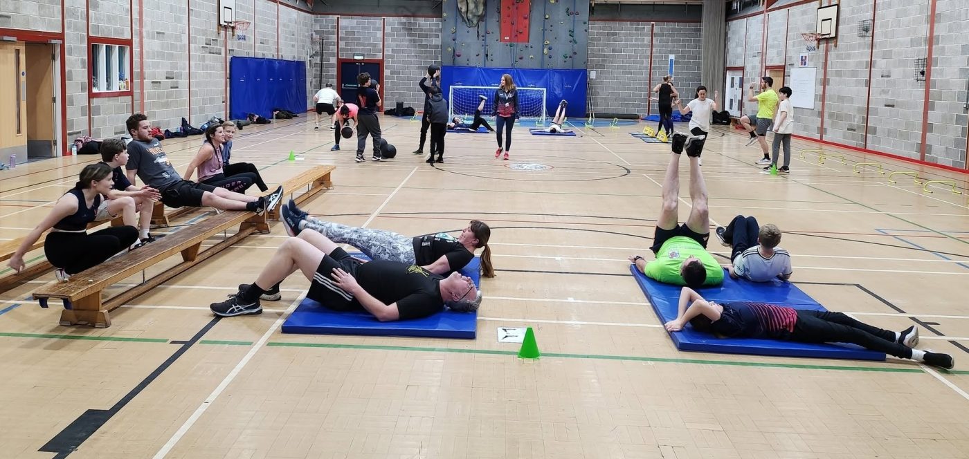 Adult members of Vale of York working through a circuit training session in the sports hall at Bubwith